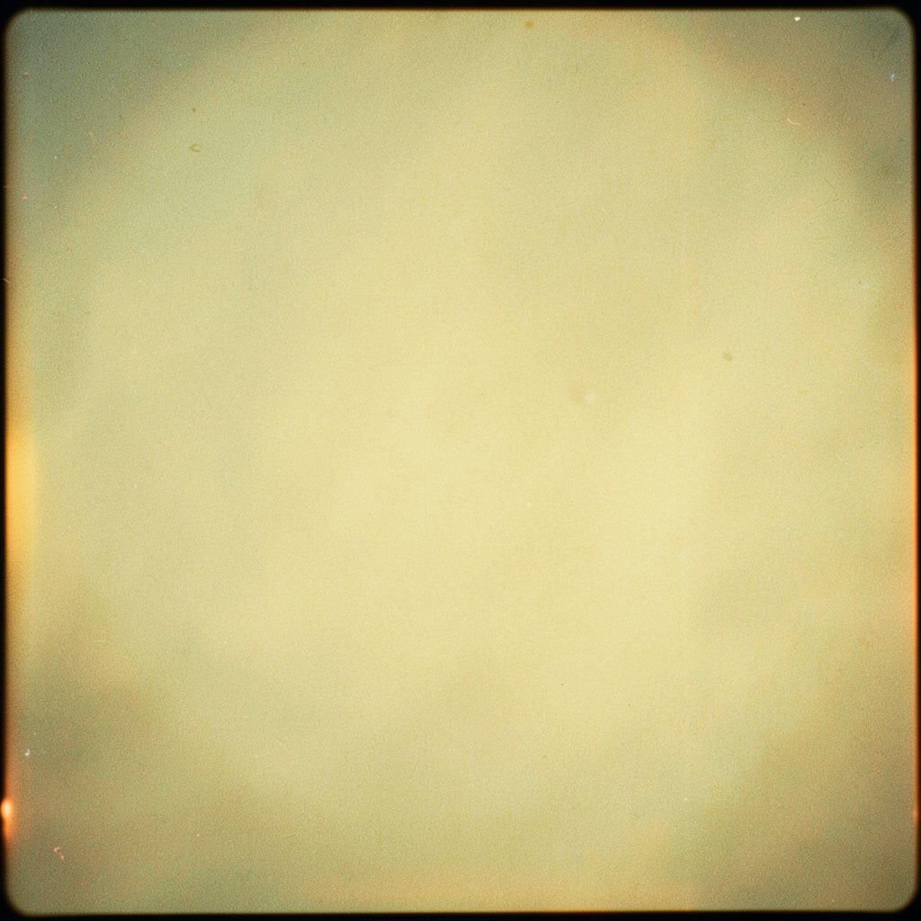 Analog film image of small grains of bulgur and couscous scattered on a wooden cutting board, with warm light and visible grain.